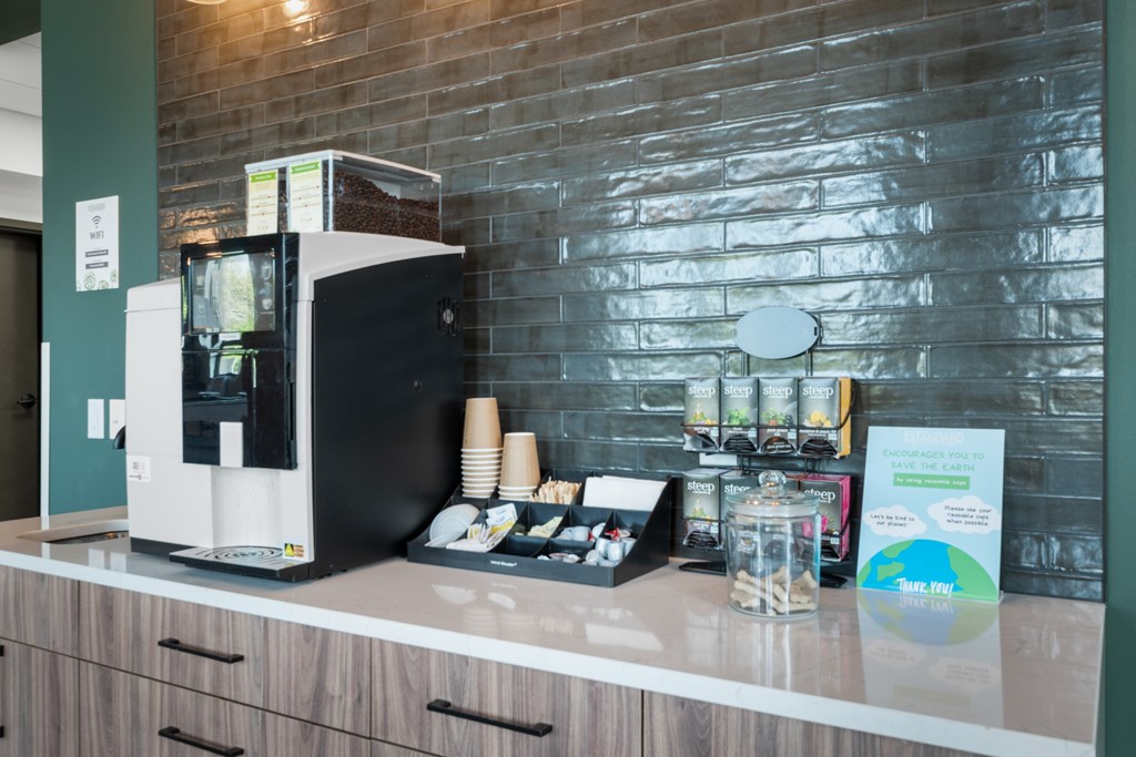 a coffee machine on a counter in front of a brick wall